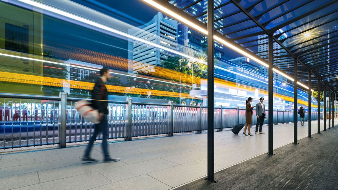 A night transit platform with linear overhead fixtures shown in an architectural lighting render