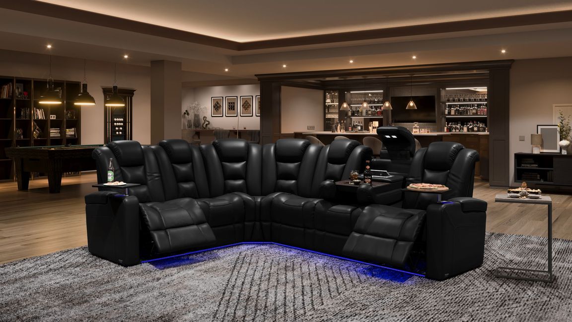 Product image of a large black leather home theater sectional sofa with recliners and tables