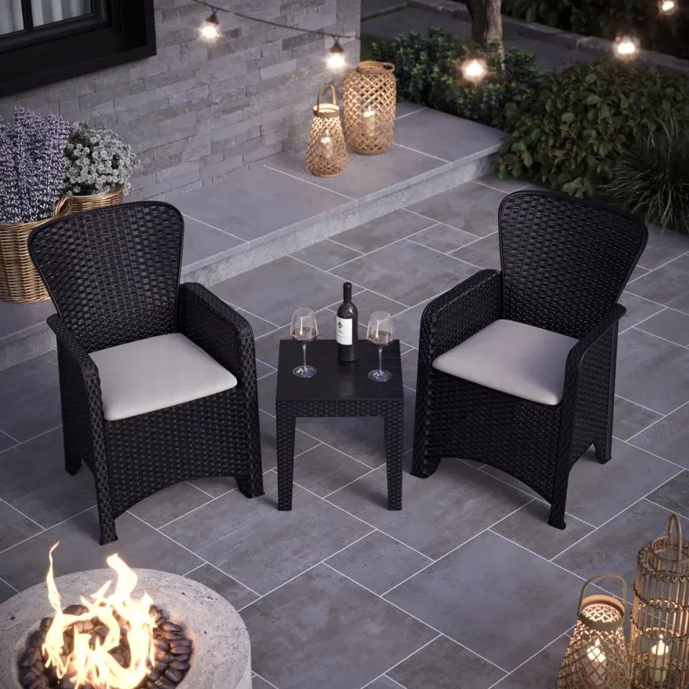 3D visualization of outdoor patio set with two wicker chairs, cushions, and small table near a fire pit