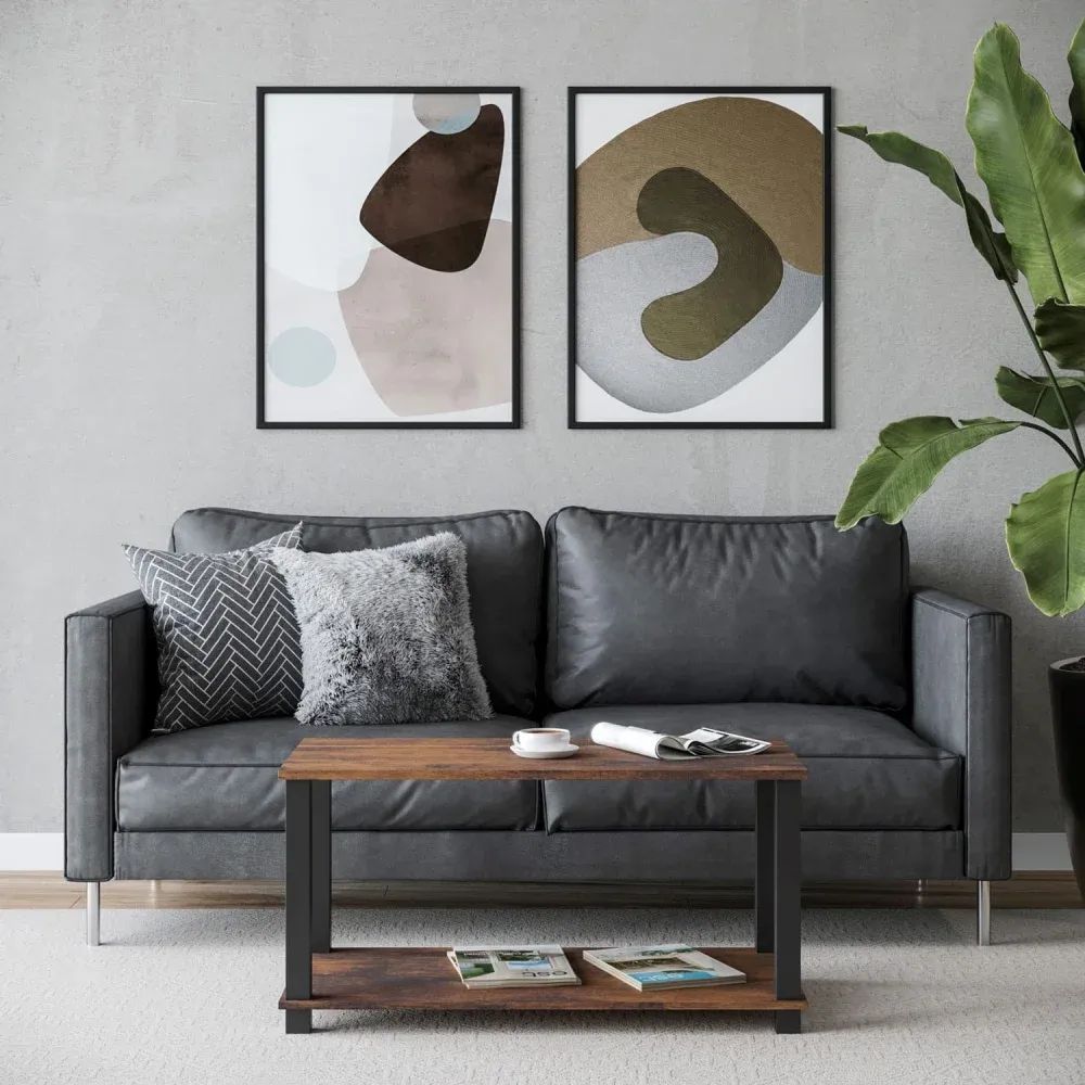3D visualization of a coffee table with storage shelf in front of a black sofa and abstract wall art