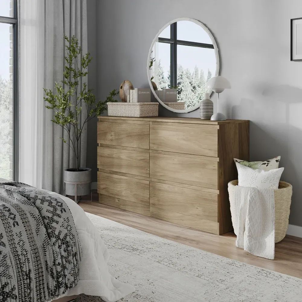 3D visualization of a wooden dresser in a bedroom with round mirror, decor accents, and basket with blanket