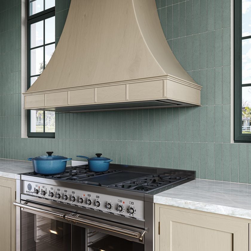 Photorealistic 3D rendering of vertical green tile behind a large range in a light wood kitchen