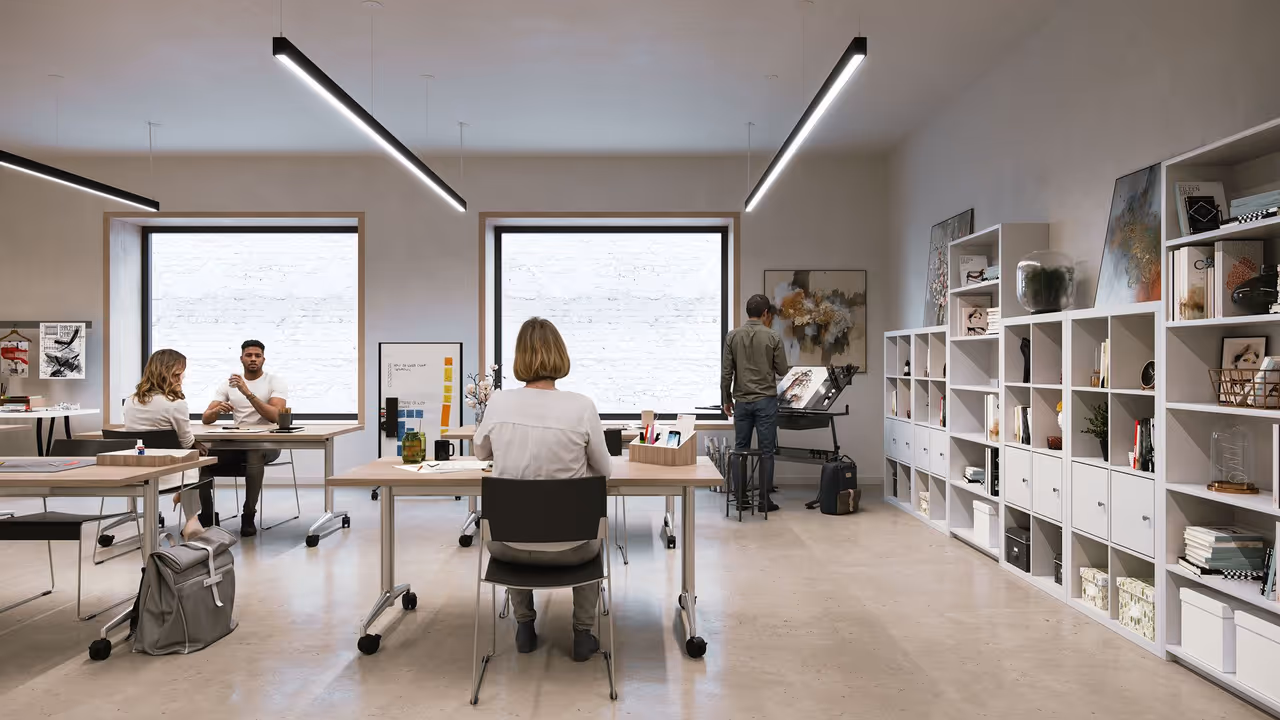An artist workroom with linear ceiling lights and open desks shown in a lifestyle product rendering