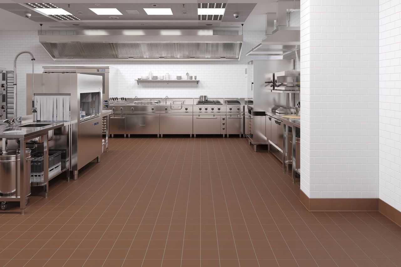 3D Rendering showing white wall tiles in a fully equipped commercial kitchen with prep tables and lighting