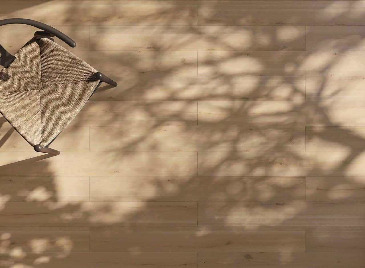 3D visualization of light natural wooden flooring with chair and tree shadows in top view