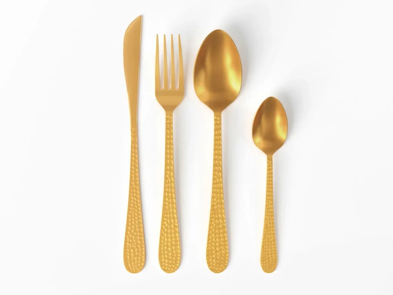 Product imagery for catalogs showing a golden fork, knife, tablespoon, and teaspoon