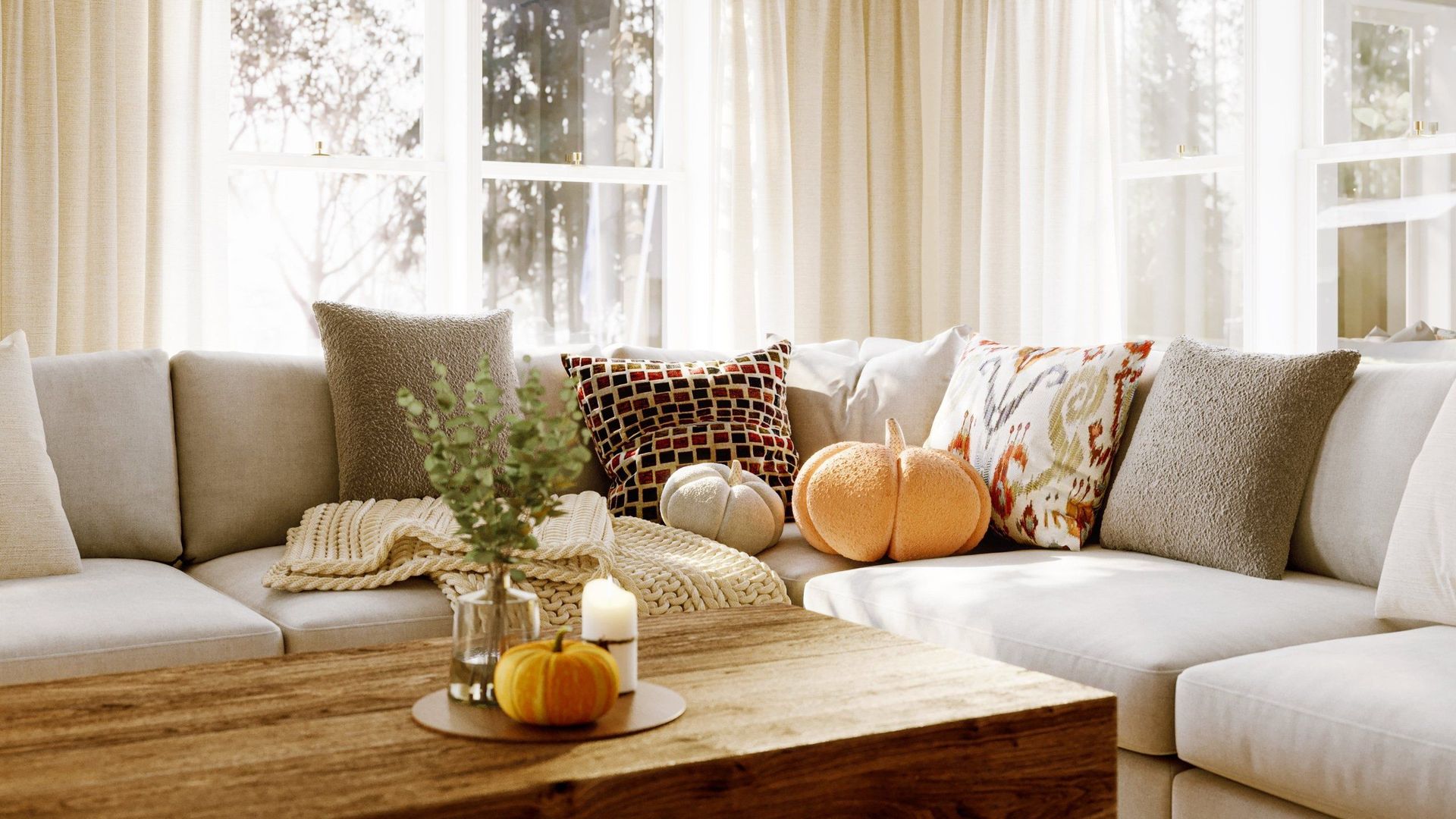 3D lifestyle visualization showcasing a cozy living room with a sofa, cushions, and pumpkins, highlighting realistic furniture rendering and 3D interior visualization.