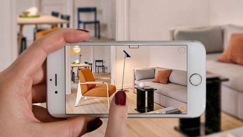 A Woman Using an Ecommerce AR Tool to Add Virtual Furnishing to the Room