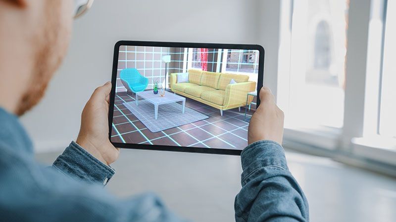 A Man Using Ecommerce Furniture AR App to Find the Best Pieces for a Living Room
