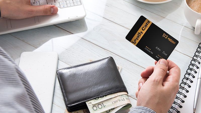 A Customer Holding a Loyalty Card Used for Furniture Marketing Loyalty Campaigns