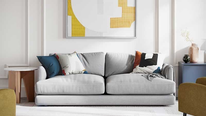A 3D Image of Grey Couch within a Lifestyle Scene