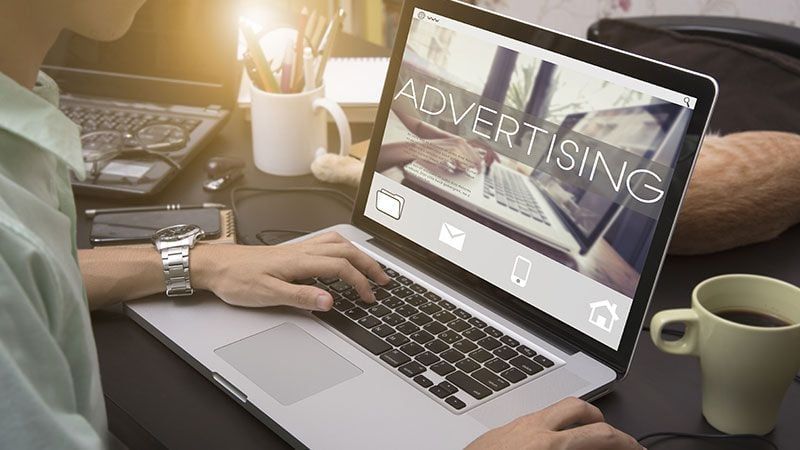 A Man Typing on a Laptop and Seeing Product Advertisement