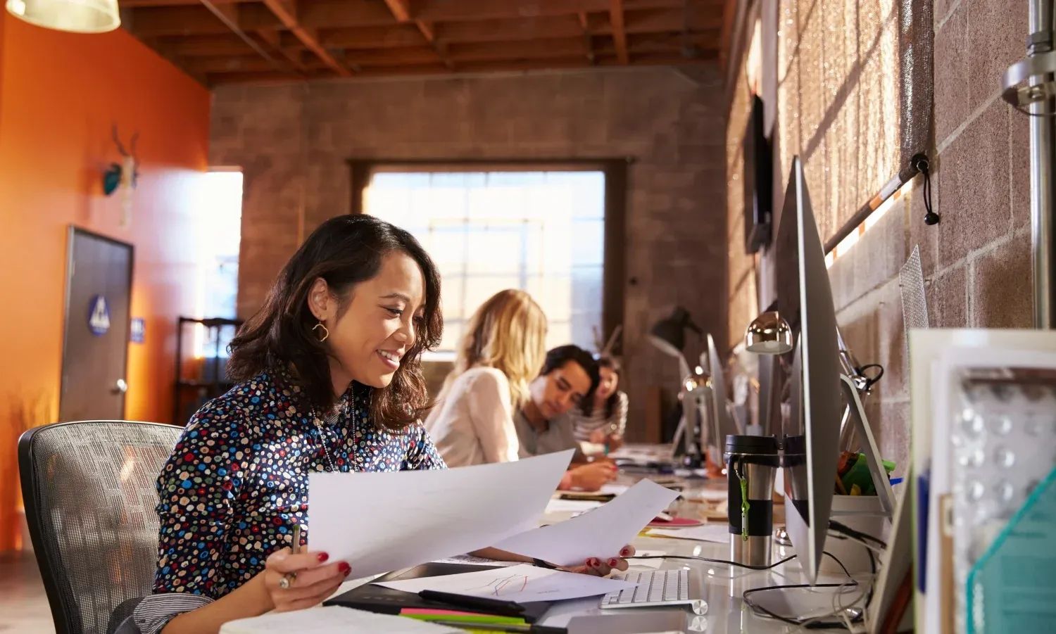 Specialists doing market research by reviewing documents with data