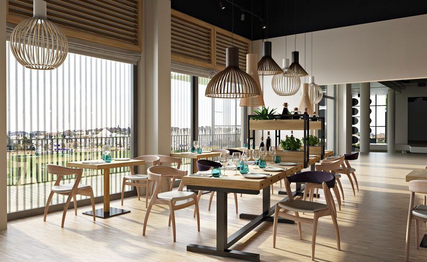 3D-rendered dining area, with a view of a sports court through the windows.