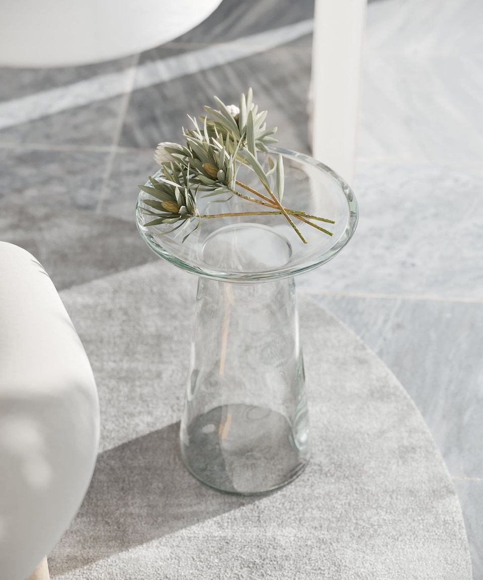 High-quality 3D rendering of a glass table with a plant, showcasing photorealistic furniture visualization and interior design.