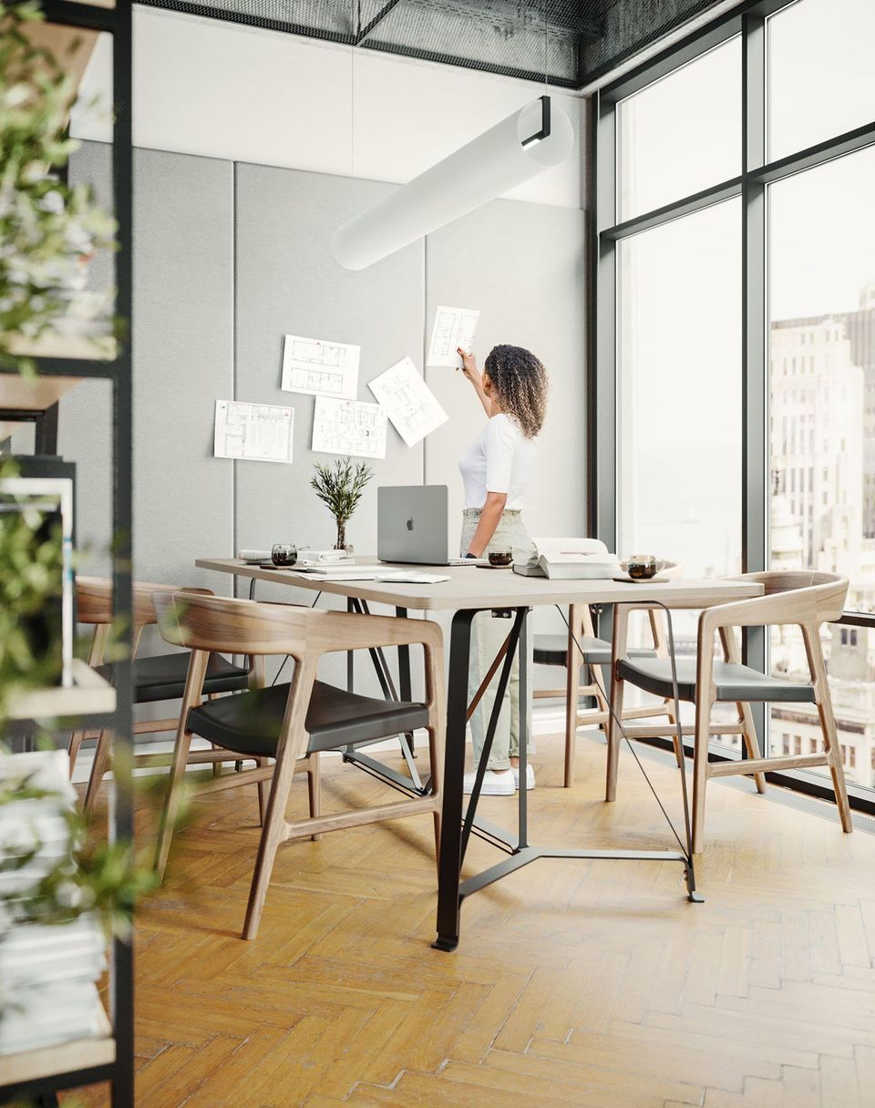 3D Visualization Of A Modern Office With A Woman Pinning Floor Plans On A Wall Panel