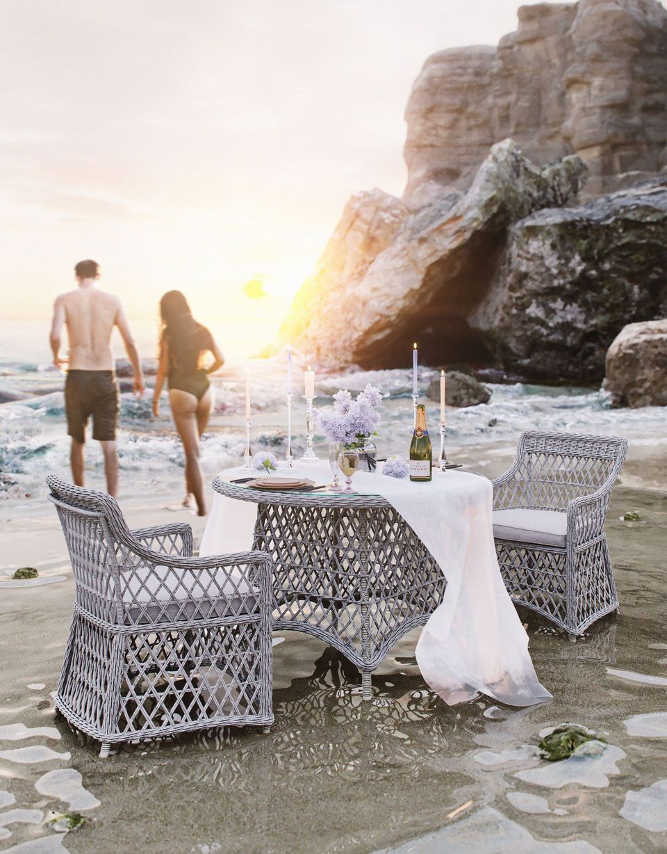 Photorealistic 3D furniture rendering of a beach scene with wicker chairs and table, showcasing 3D lifestyle visualization and CGI rendering.
