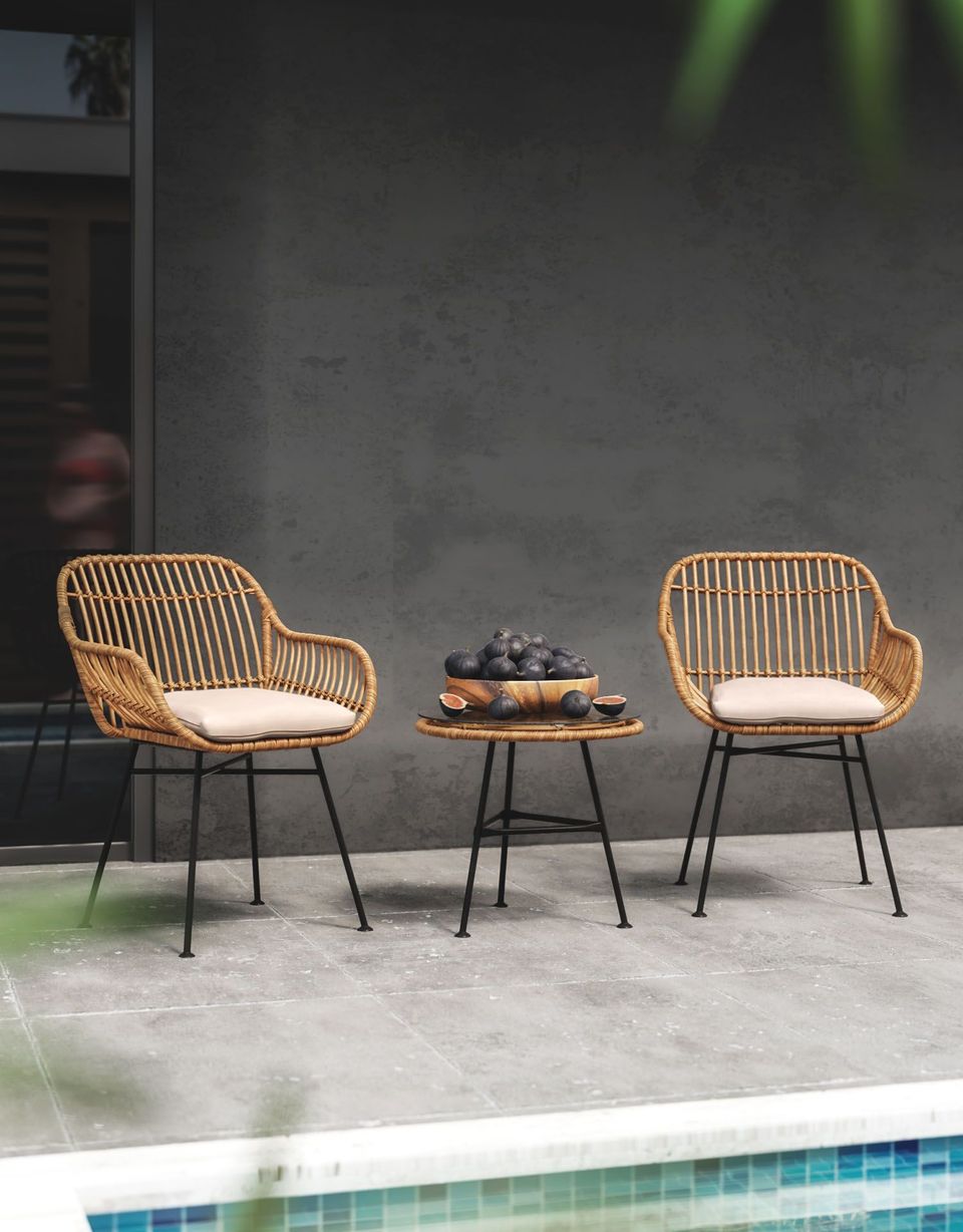 3D Rendering Of A Poolside Seating Area With Rattan Chairs, A Small Table, And A Bowl Of Figs