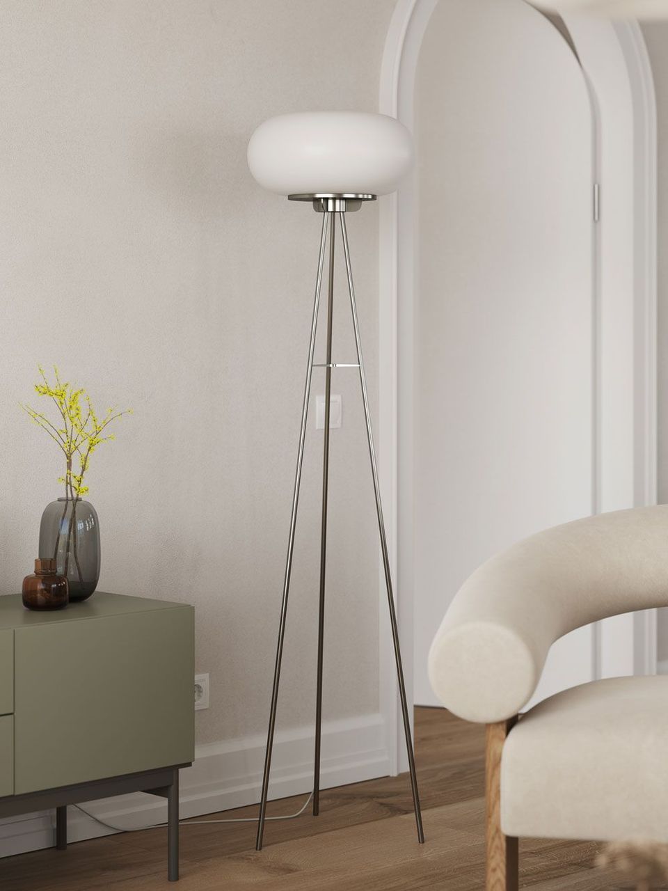 Lifestyle Rendering Of A Modern Floor Lamp With A Tripod Base Next To A Curved Chair And Sideboard