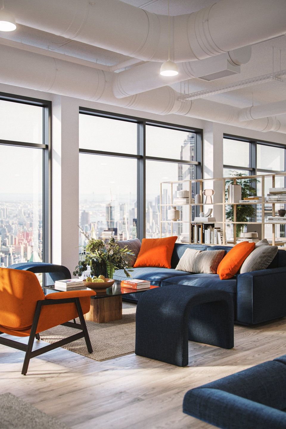Lifestyle Rendering Of A Modern Office Lounge With Blue Sofas And Bold Orange Accent Pillows