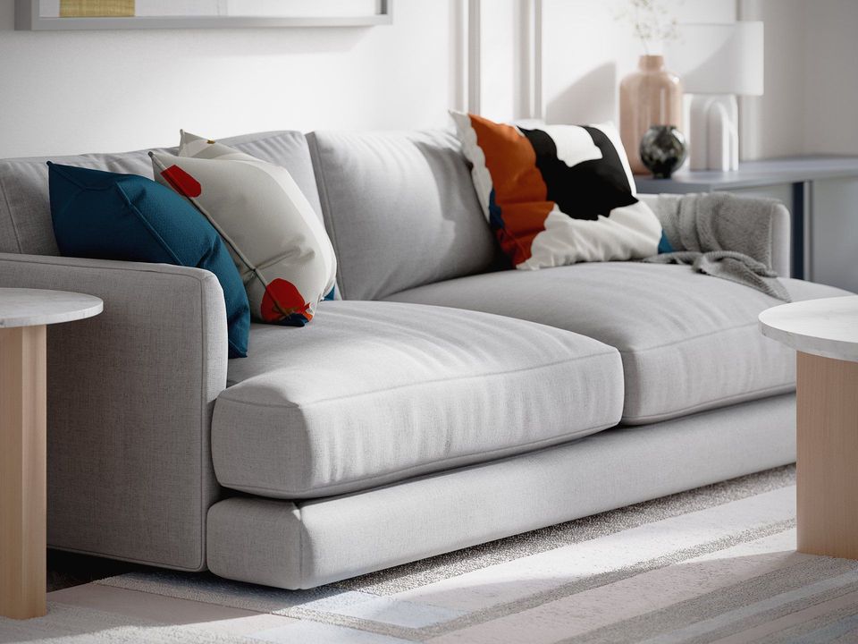 Realistic 3D rendering of a trendy sofa with cushions, showcasing photorealistic house fittings visualization and interior design.