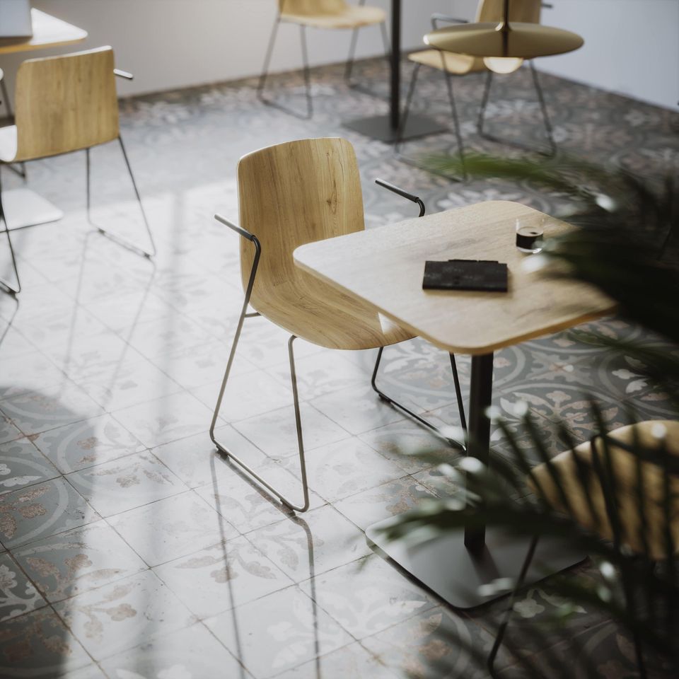 Lifestyle Rendering of a Cafe Interior with Wooden Tables, Chairs, and Patterned Floor Tiles