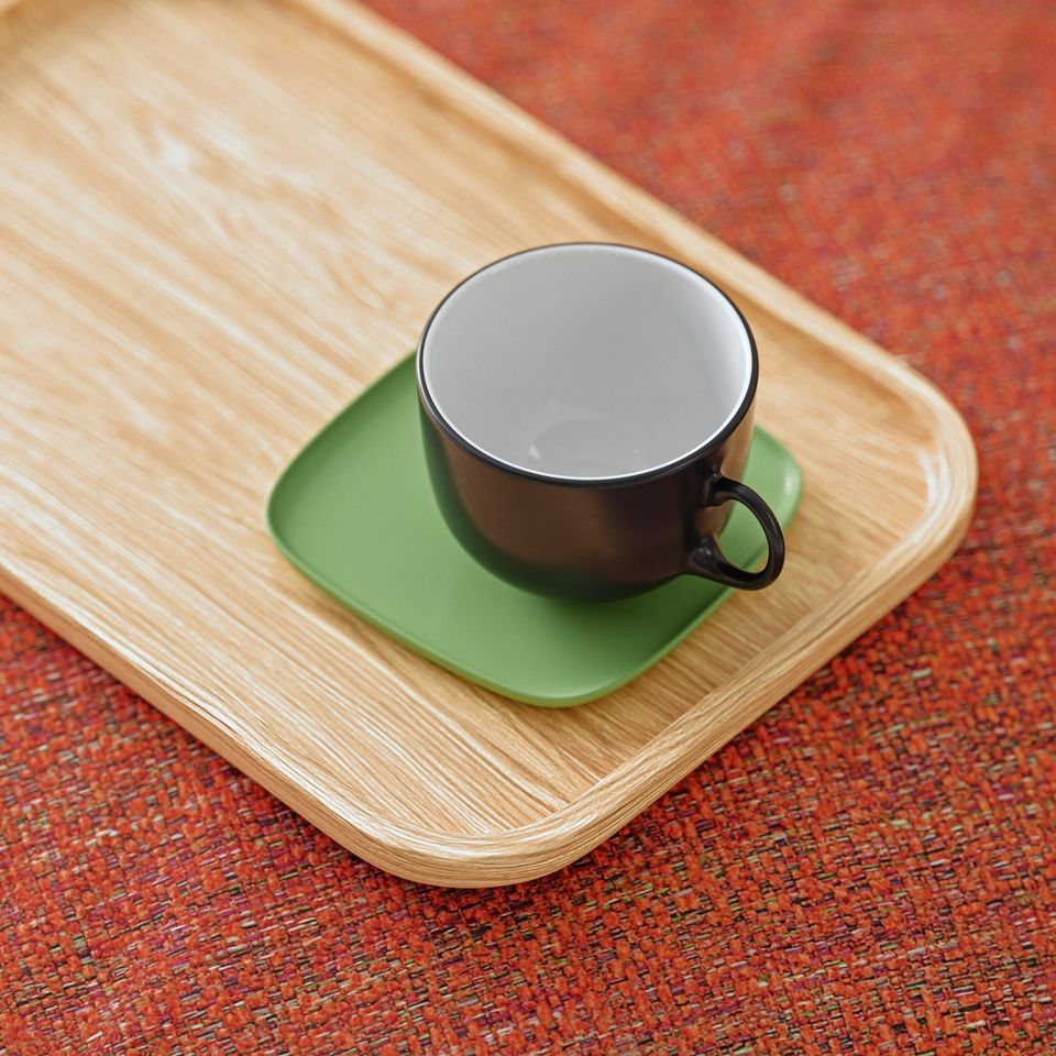 3D Rendering Of A Cup And Saucer On A Wooden Tray Placed On A Red Textured Fabric