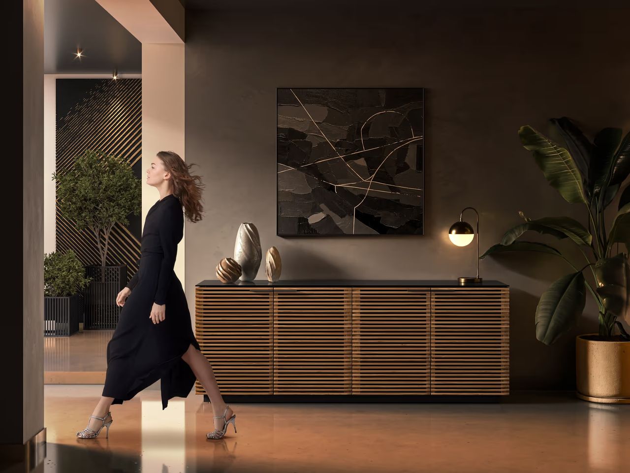 Lifestyle 3D render of a modern interior with a woman walking past a sideboard, showing movement in the interior setup