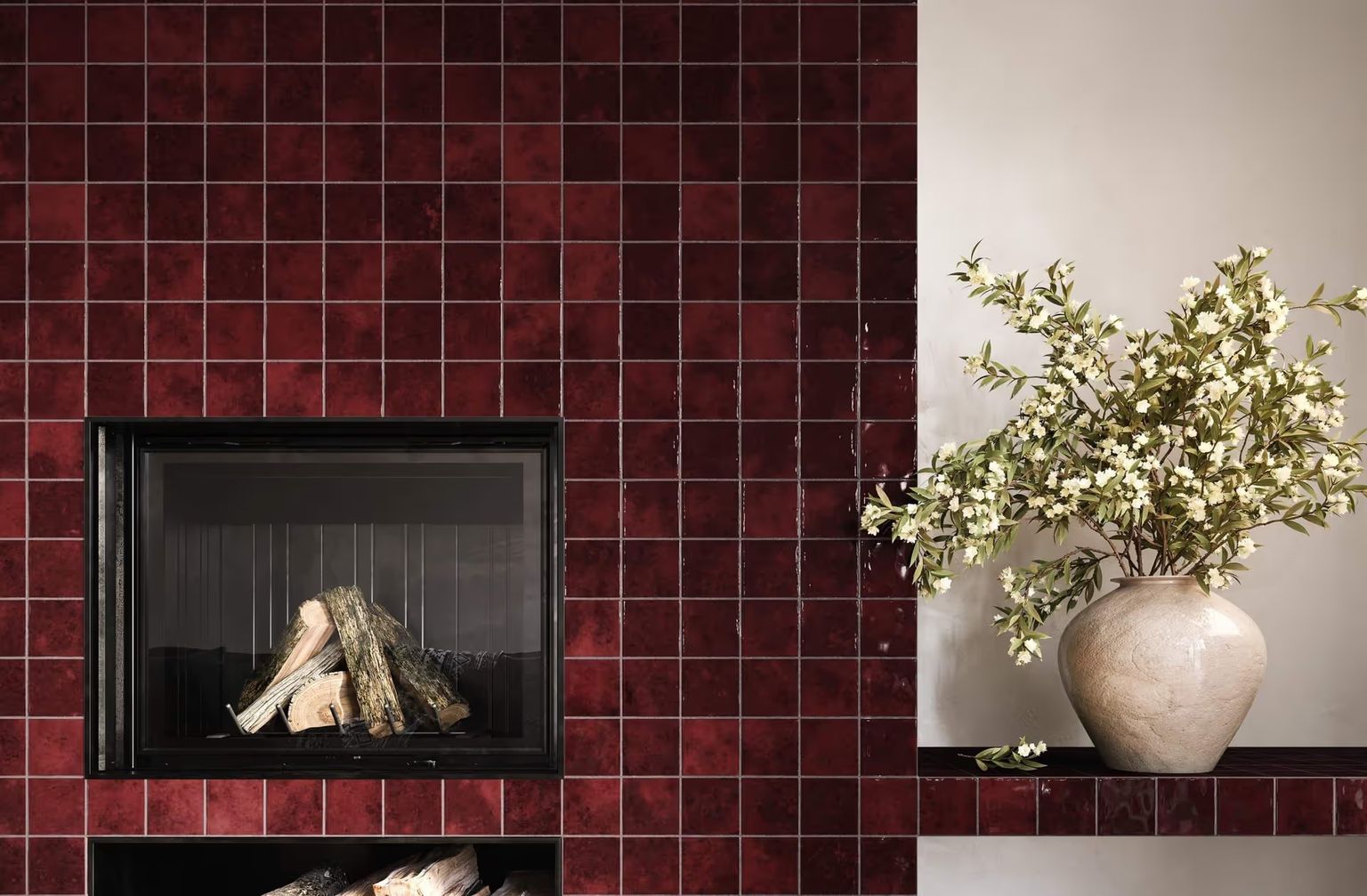 CGI Photography shows a fireplace niche framed by deep burgundy tiles, with a ceramic vase and leafy stems on the side