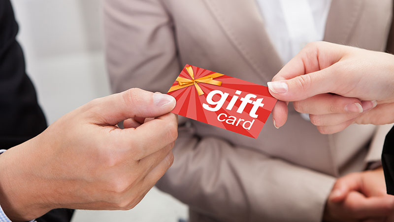 A Person Passing a Brand Gift Card which is a Perfect Collateral Item