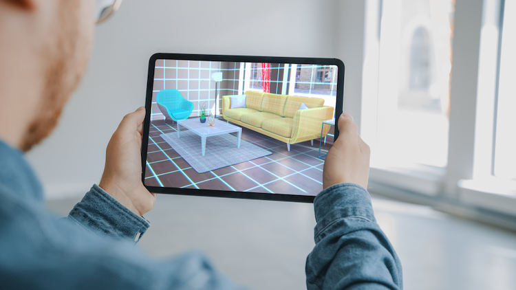 Man Using Augmented Reality to Choose a Living Room Furniture Set