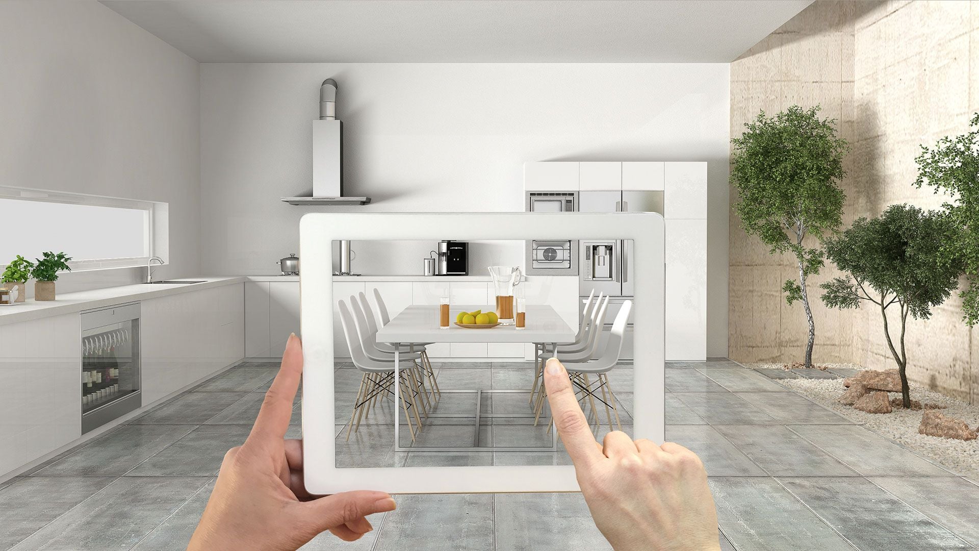 Shopper holding a tablet to preview a kitchen in augmented reality