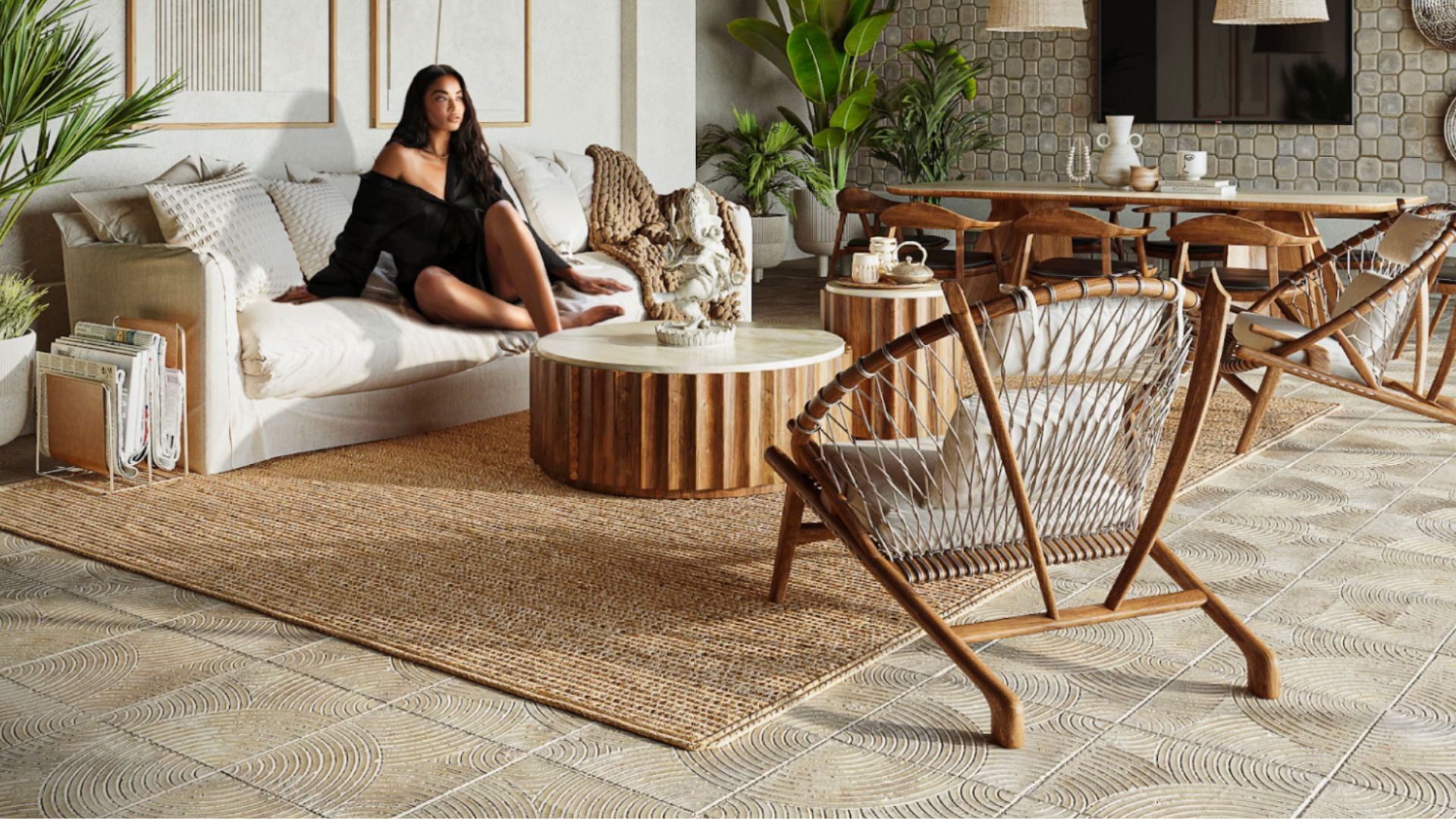 A well-known home decor influencer sits elegantly in a modern living room setting, surrounded by stylish furniture pieces, demonstrating the upscale ambiance and comfort of a brand’s furniture line.
