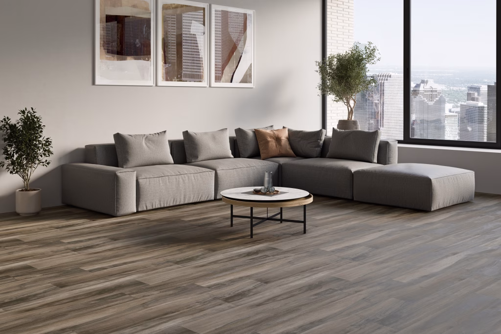 Flooring product rendering of Reflect Tranquil Timber Walnut vinyl planks in a high-rise living room with a city view