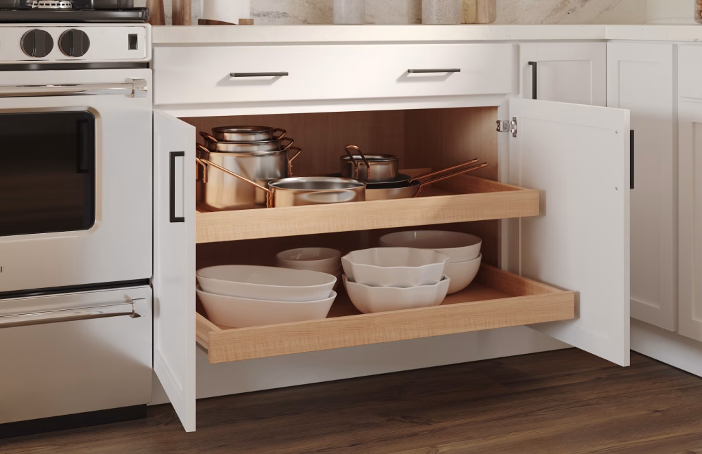 3D visualization of a white base cabinet with two roll-out trays extended showing pots and bowls