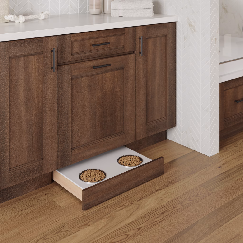 3D visualization of a toe-kick pet feeding station with two bowls pulled out from a dark stained cabinet