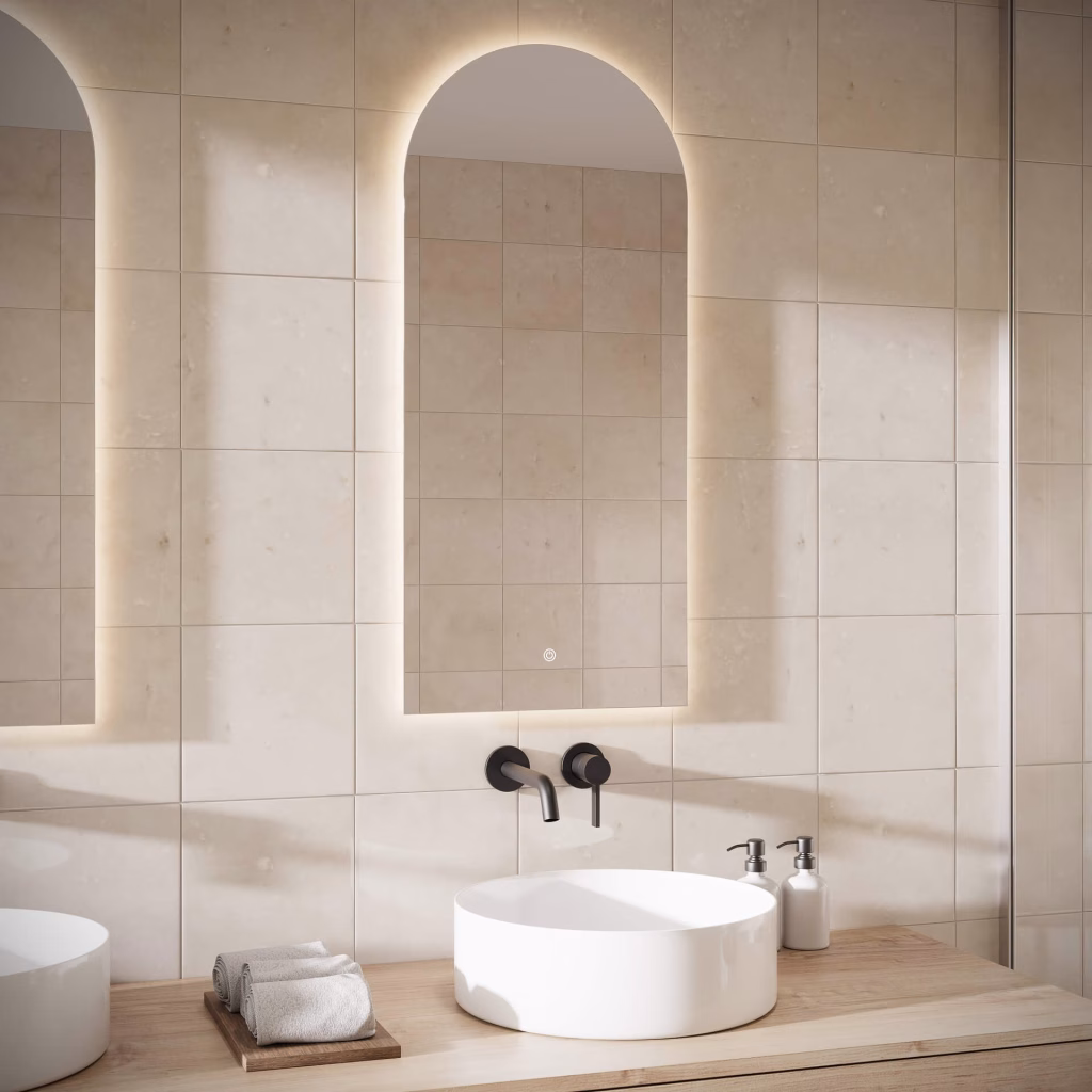 CGI of an arched backlit LED mirror above a round vessel basin and gun metal wall faucet