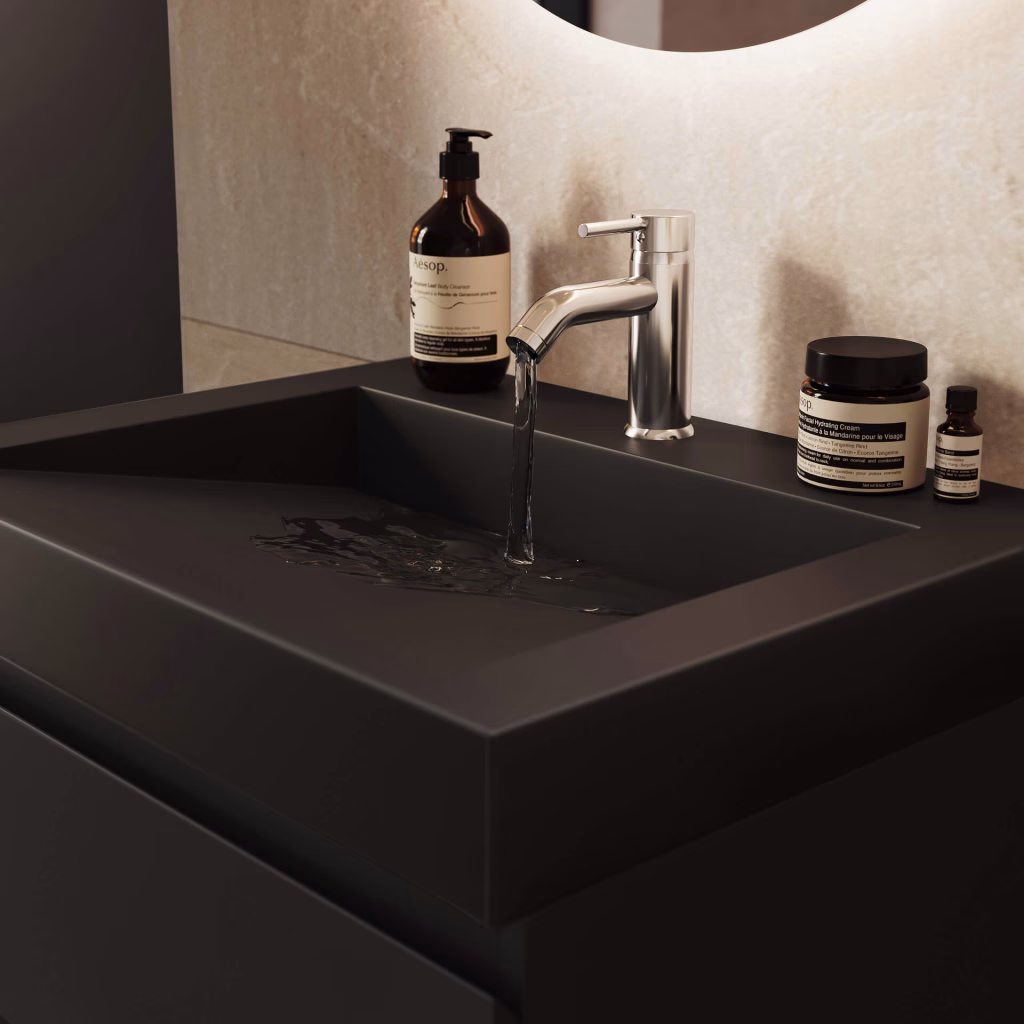 Close-up CGI of water running from a chrome faucet into the black basin of a 60 cm vanity
