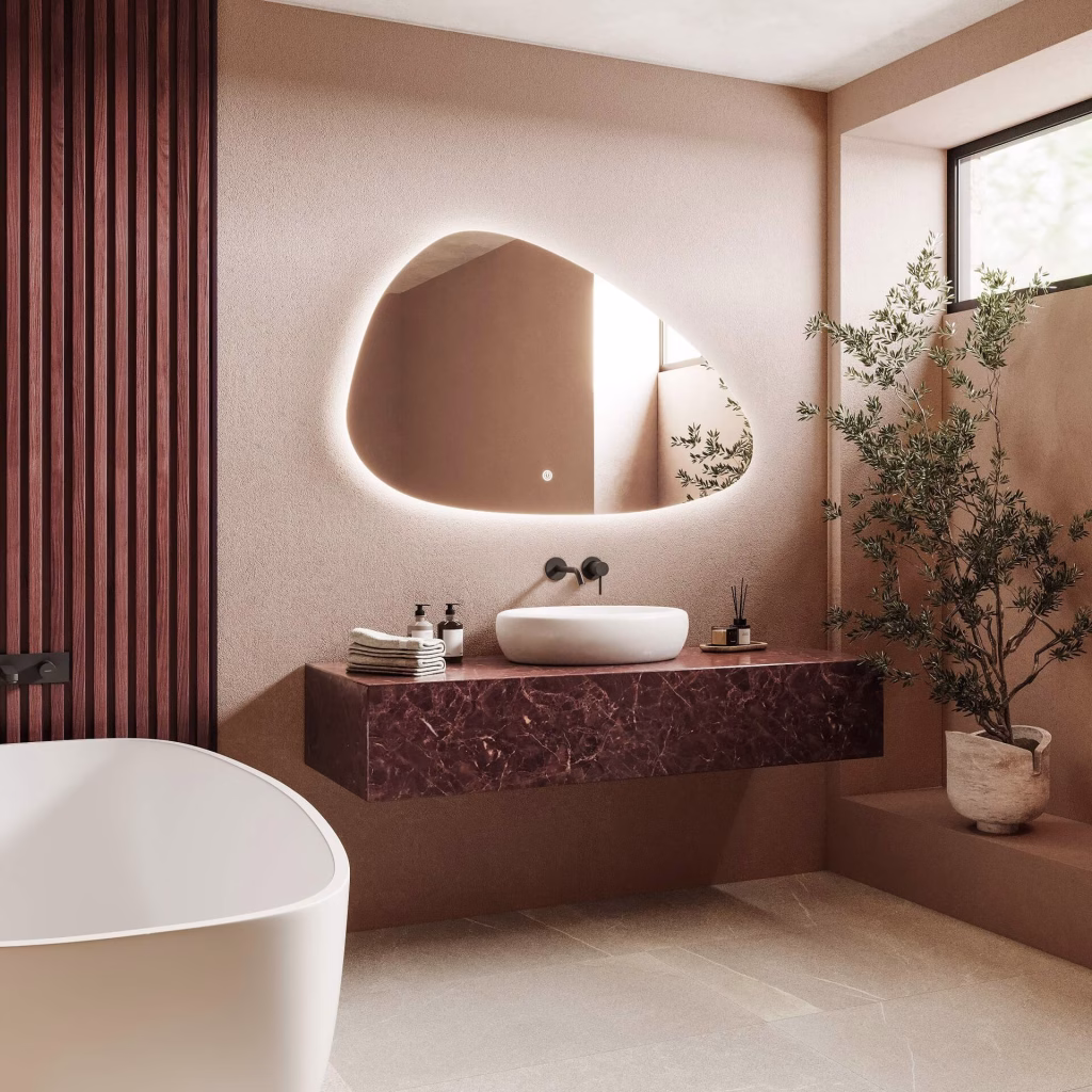 Angled 3D rendering of a backlit LED mirror above a red marble vanity with a freestanding bathtub in the foreground