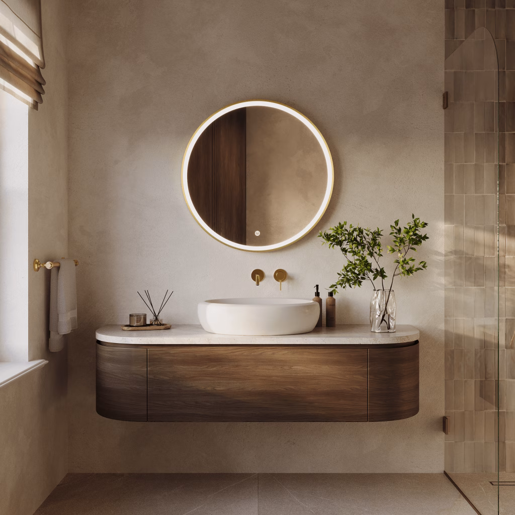 Front-view CGI of a large round gold-framed LED mirror above a curved walnut vanity with vessel basin