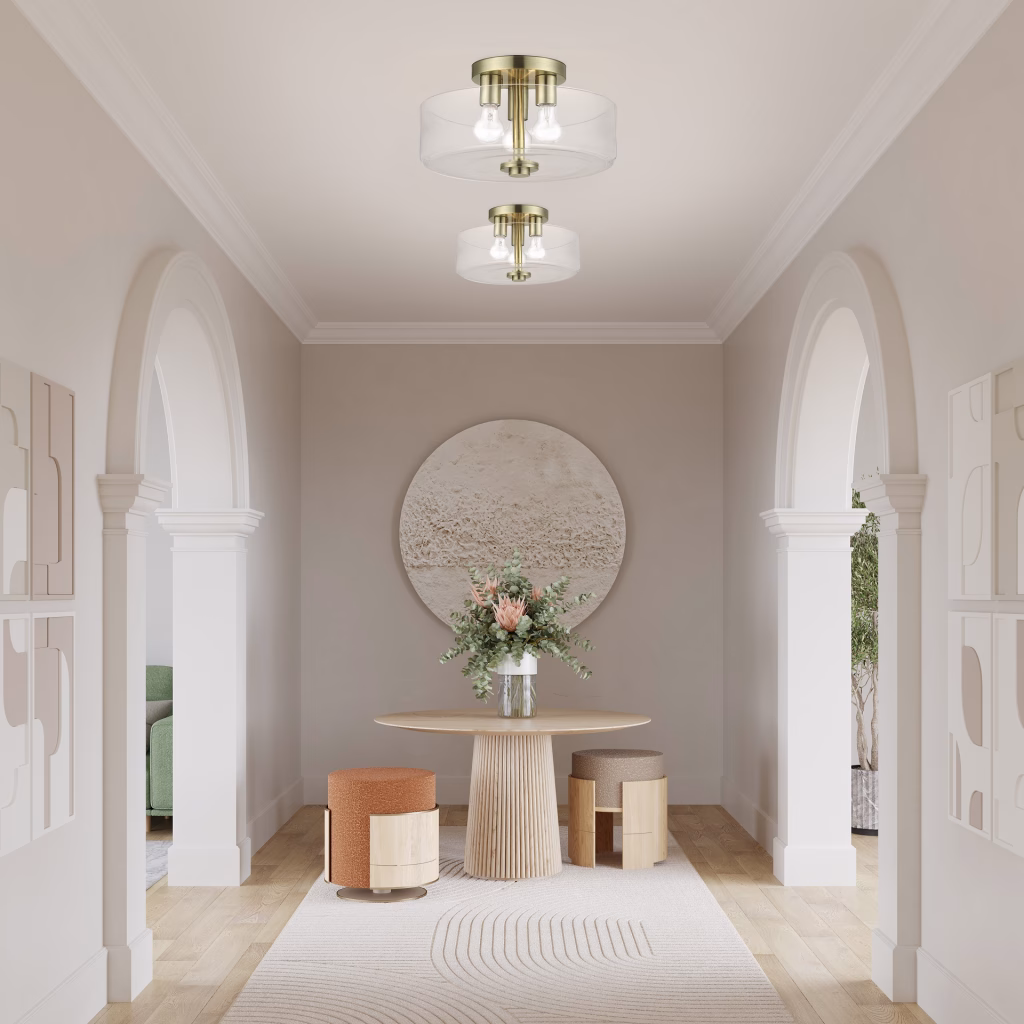 3D rendering of two clear glass drum semi-flush ceiling lights in brass for Livex Lighting in an arched hallway