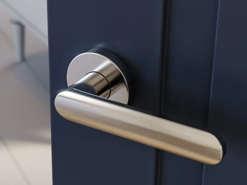 Close-up 3D render of a brushed steel lever handle on a navy interior door