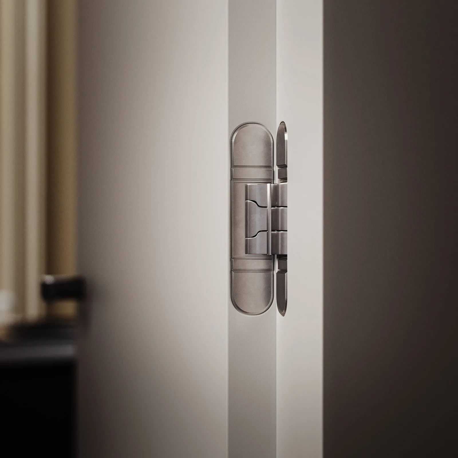 Close-up 3D render of a concealed door hinge in satin nickel set into a white door edge