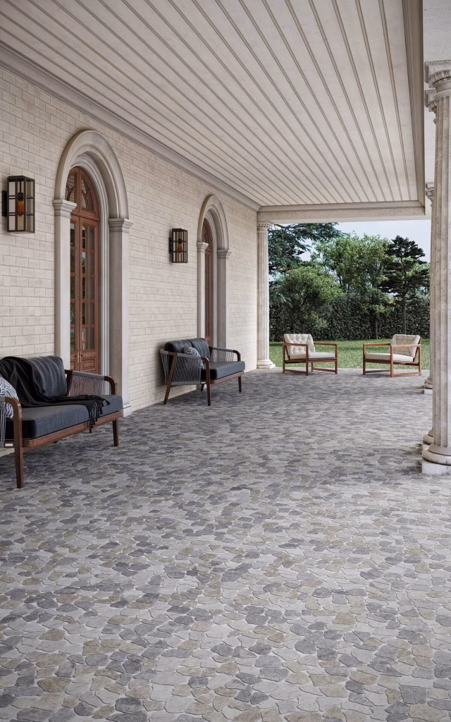 3D render of a columned porch floored in Cobbles Tumbled marble in a grey, blue and taupe mix