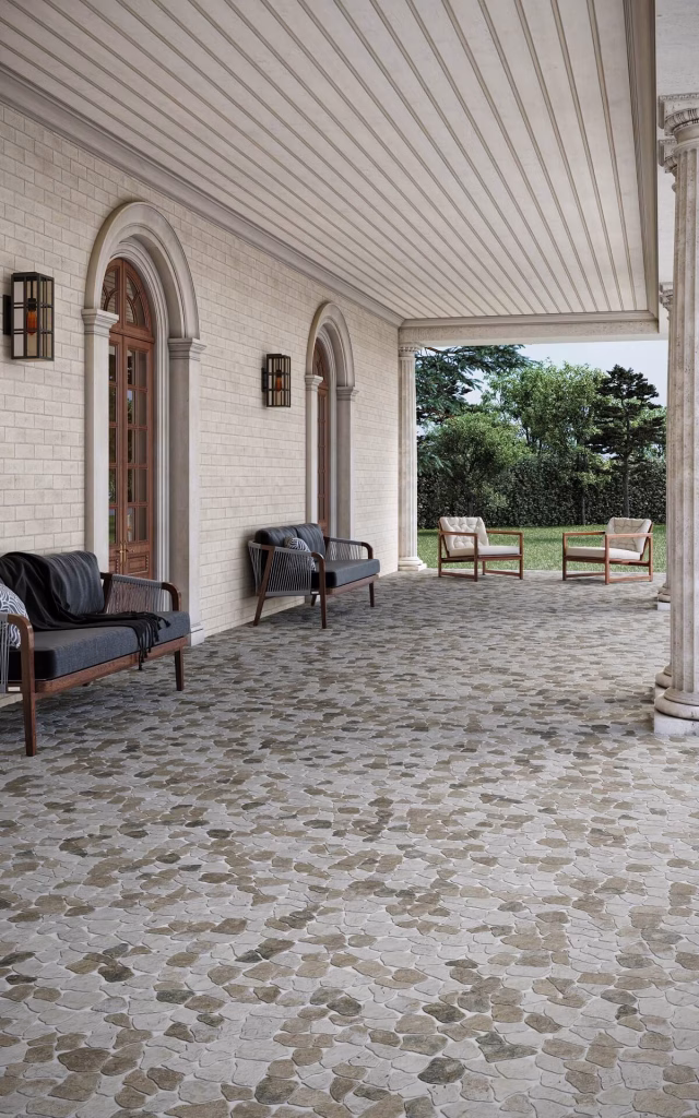 3D render of a columned porch floored in Cobbles Tumbled marble in a tan and grey mix