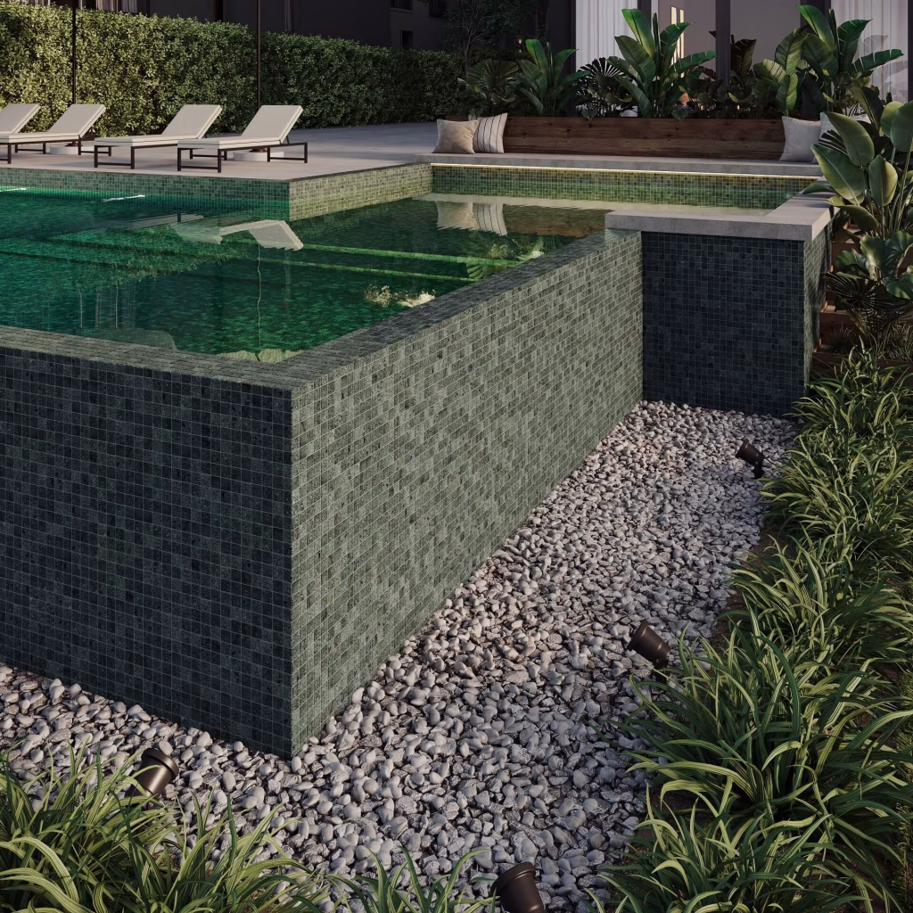 CGI render of a raised pool wall clad in green stone mosaic above a pebble bed with garden lights at dusk