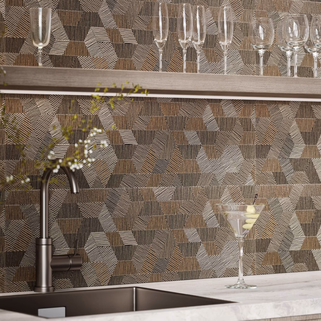 Close-up render of a home bar backsplash in bronze geometric relief tile, with glassware on a floating shelf