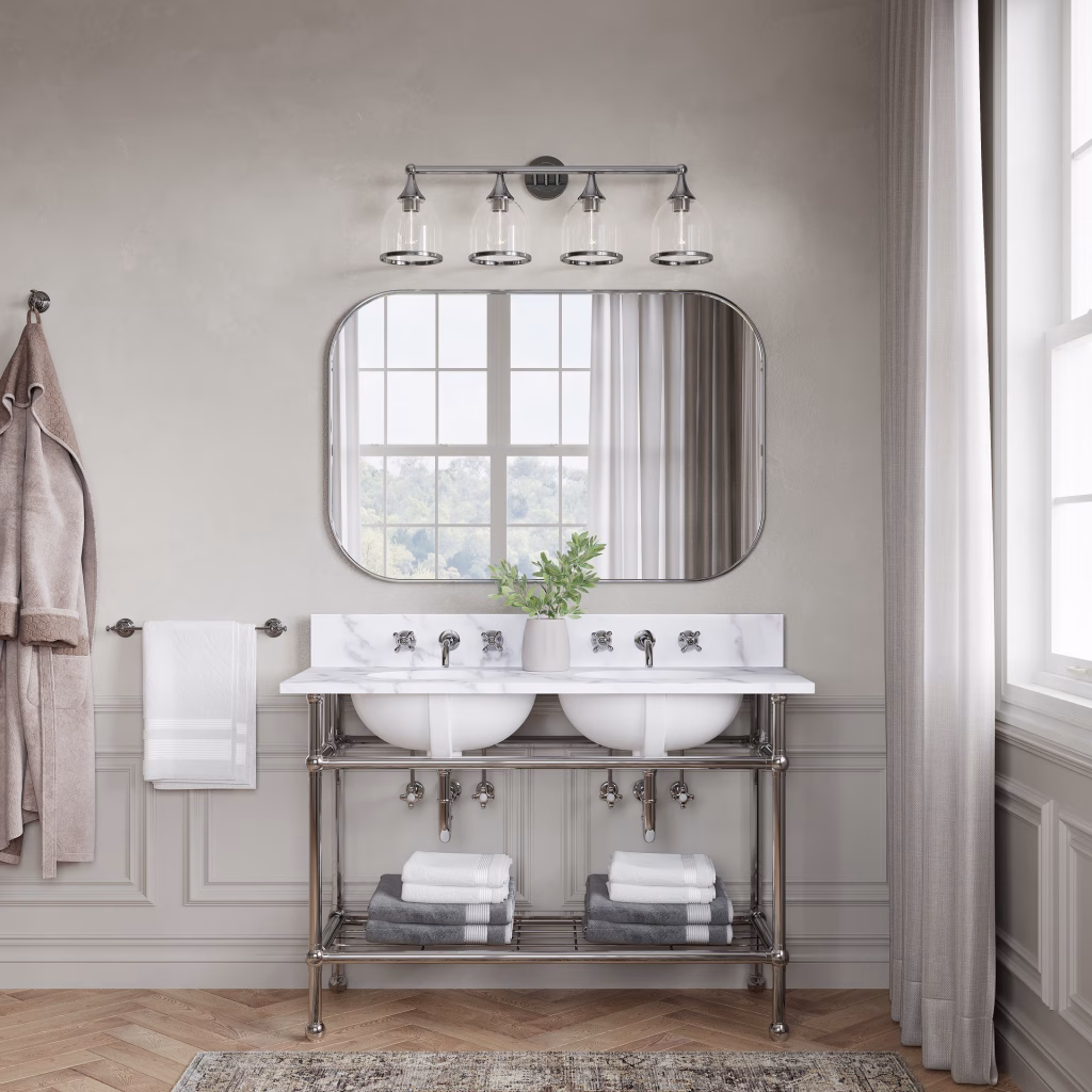 3D rendering of the Livex Lighting Ashridge four-light vanity sconce in chrome, shades down, over a double console sink and a rounded mirror